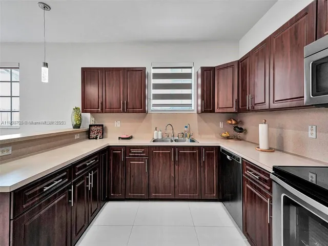 a kitchen with a sink stove top oven and cabinets