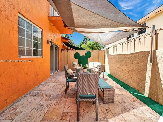 a view of a patio with table and chairs and potted plants