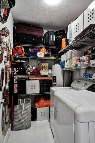 a room with stainless steel appliances kitchen island a table and chairs in it