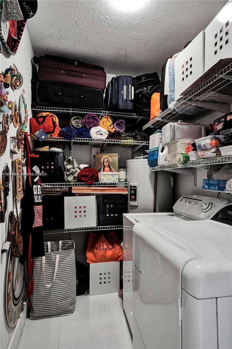 7565 Northwest 177th Terrace, Unit 7565 Hialeah, FL 33015 - Photo 20 of 35 a room with stainless steel appliances kitchen island a table and chairs in it