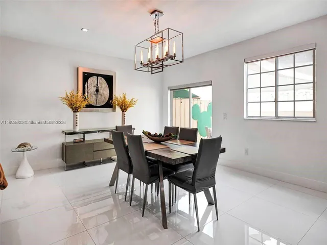 a view of a dining room with furniture and a chandelier