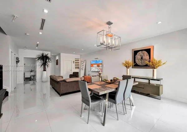 a dining room with furniture and a chandelier