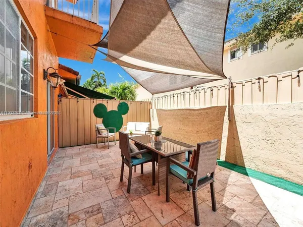 a view of balcony with table and chairs
