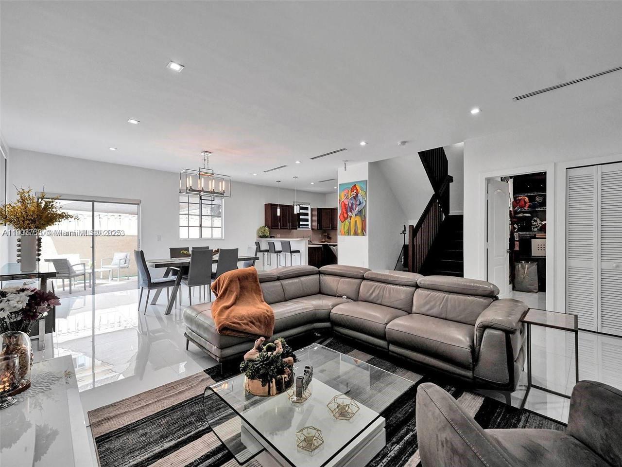 7565 Northwest 177th Terrace, Unit 7565 Hialeah, FL 33015 - Photo 4 of 35 a living room with furniture and a large window