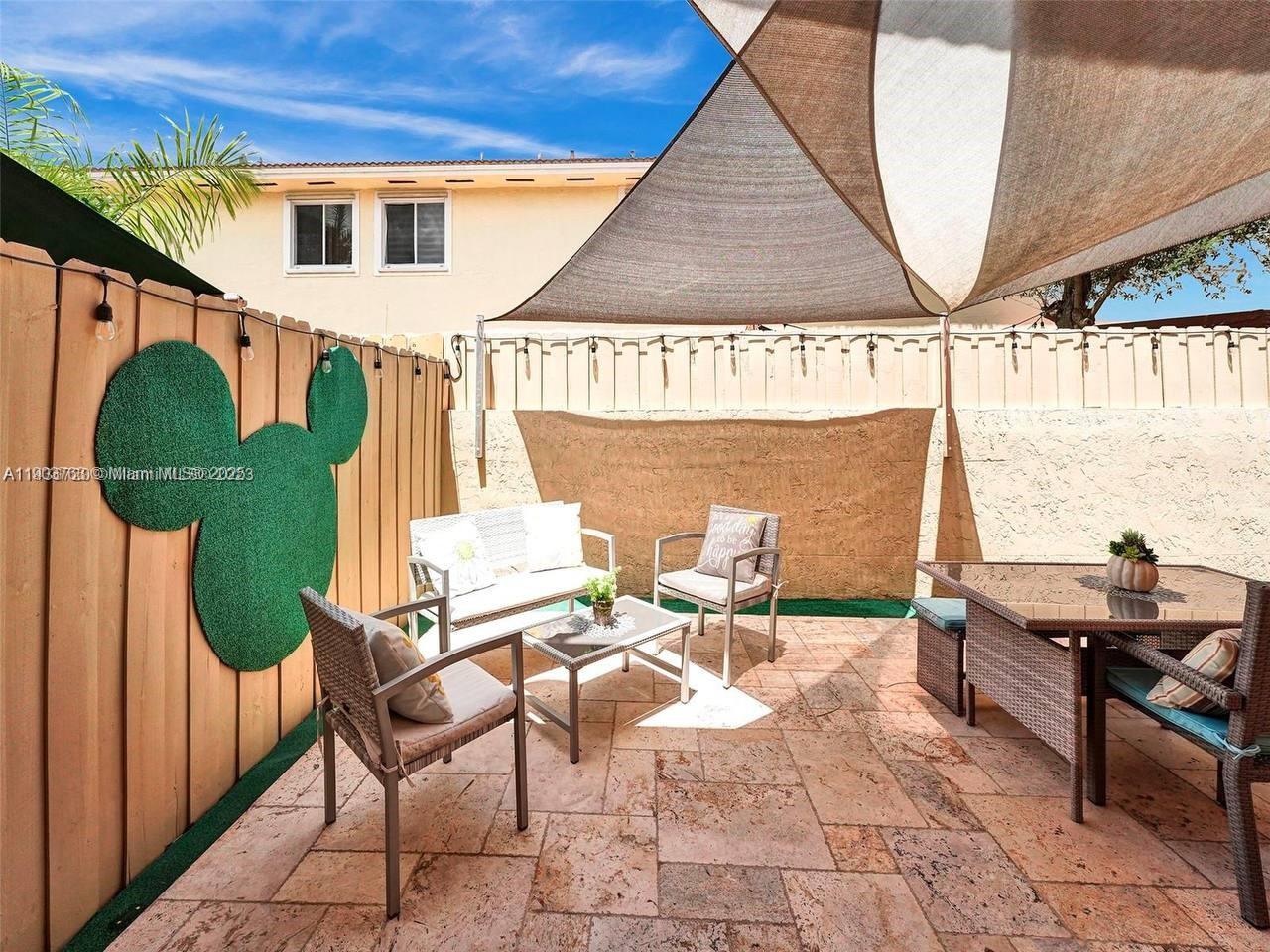 7565 Northwest 177th Terrace, Unit 7565 Hialeah, FL 33015 - Photo 9 of 35 a outdoor space with patio couch and a potted plant