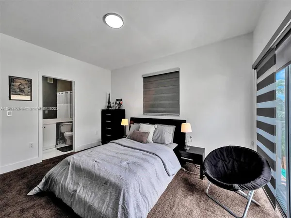 a bedroom with a bed and cabinets