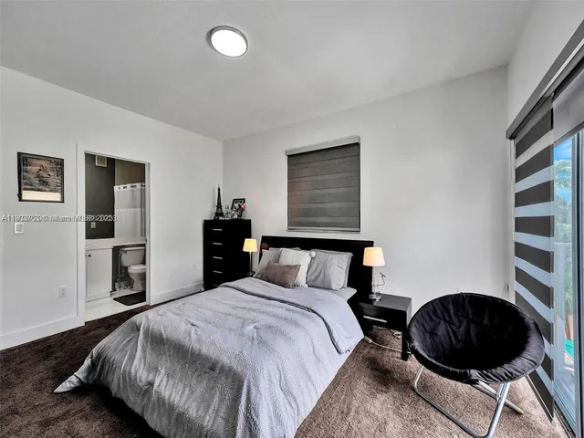 a bedroom with a bed and cabinets