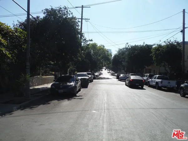 a view of street with parked cars
