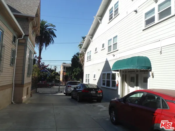 a couple of cars parked in front of a house