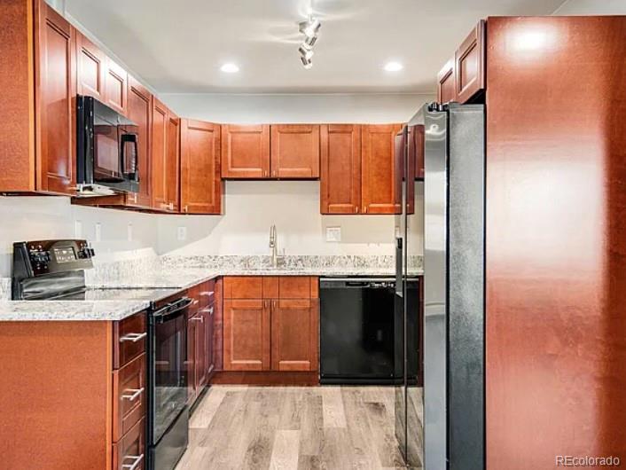 1600 Yates Street Denver, CO 80204 - Photo 18 of 20 a kitchen with stainless steel appliances granite countertop a stove a sink and a refrigerator