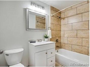 1600 Yates Street Denver, CO 80204 - Photo 6 of 20 a bathroom with a sink toilet vanity and tub