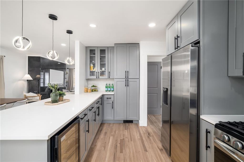 108 Burbank Drive Southwest Atlanta, GA 30314 - Photo 20 of 53 a kitchen with kitchen island granite countertop a sink a refrigerator and a stove