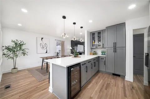 a kitchen with a sink stove and cabinets