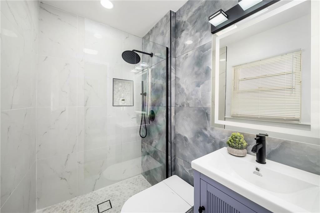 108 Burbank Drive Southwest Atlanta, GA 30314 - Photo 35 of 53 a bathroom with a sink toilet and shower