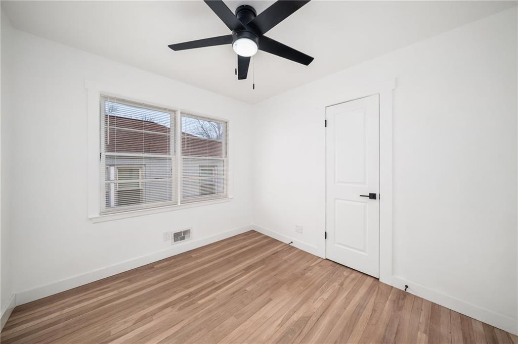 108 Burbank Drive Southwest Atlanta, GA 30314 - Photo 39 of 53 a view of an empty room with wooden floor and a window