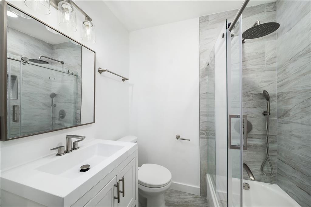 108 Burbank Drive Southwest Atlanta, GA 30314 - Photo 40 of 53 a bathroom with a sink mirror toilet and shower