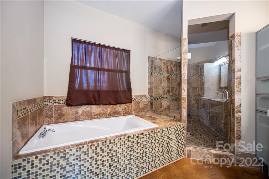 2020 Marquesas Avenue Tega Cay, SC 29708 - Photo 15 of 48 a bathroom with a bathtub and a shower