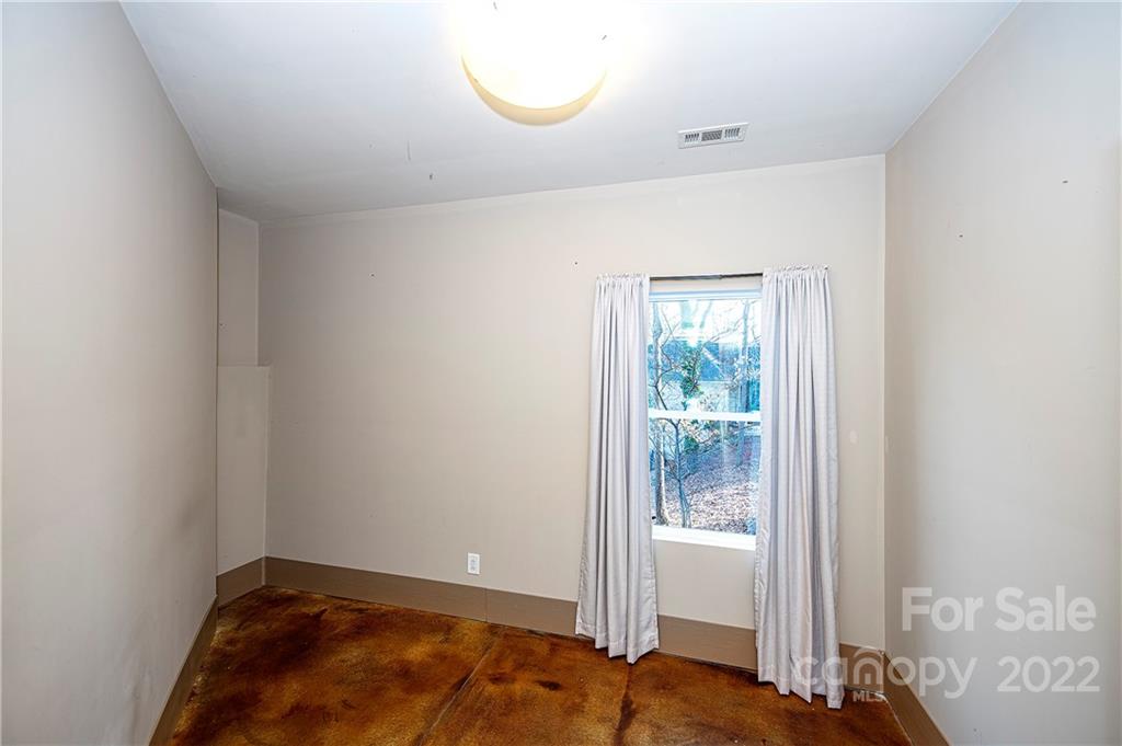 2020 Marquesas Avenue Tega Cay, SC 29708 - Photo 21 of 48 a view of an empty room with wooden floor and a window