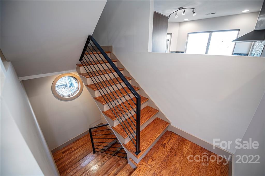 2020 Marquesas Avenue Tega Cay, SC 29708 - Photo 25 of 48 a view of staircase with wooden floor