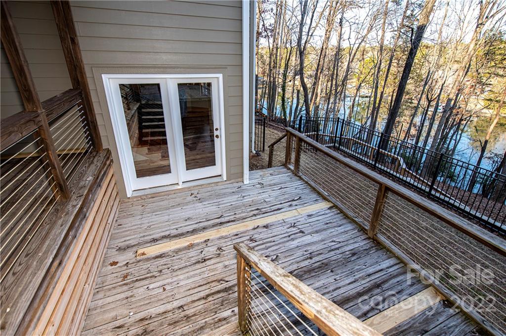 2020 Marquesas Avenue Tega Cay, SC 29708 - Photo 42 of 48 a view of a balcony with wooden floor and large trees