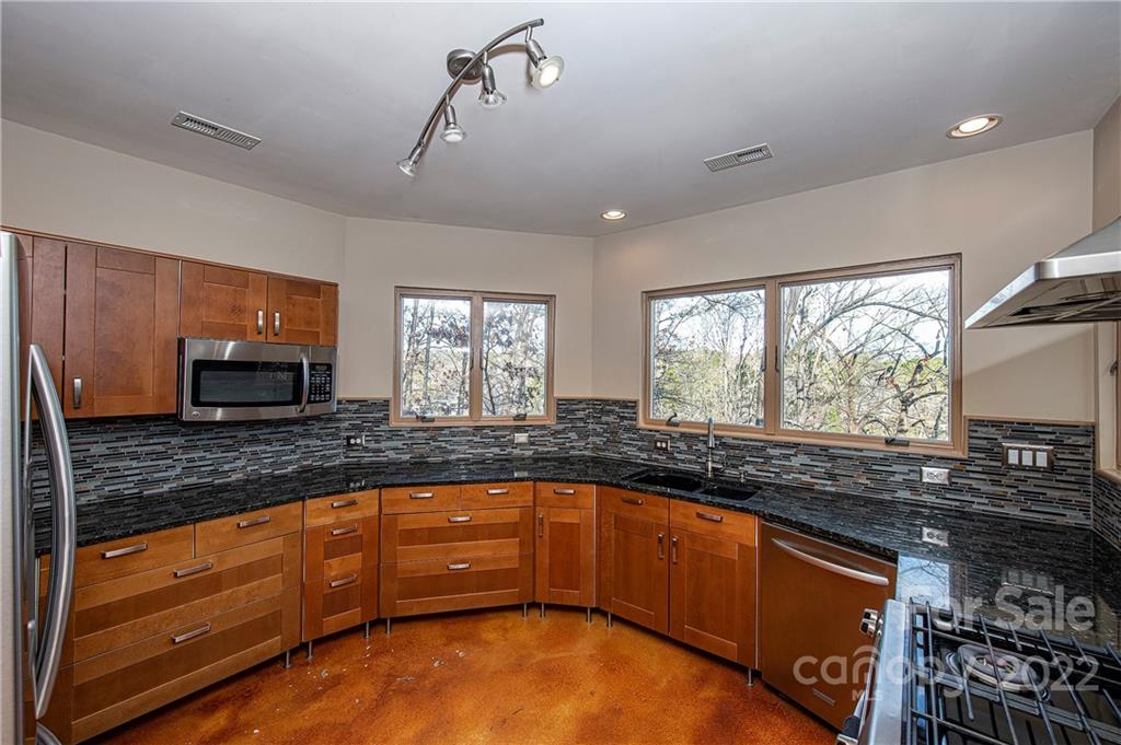 2020 Marquesas Avenue Tega Cay, SC 29708 - Photo 6 of 48 a kitchen with granite countertop a stove and a sink