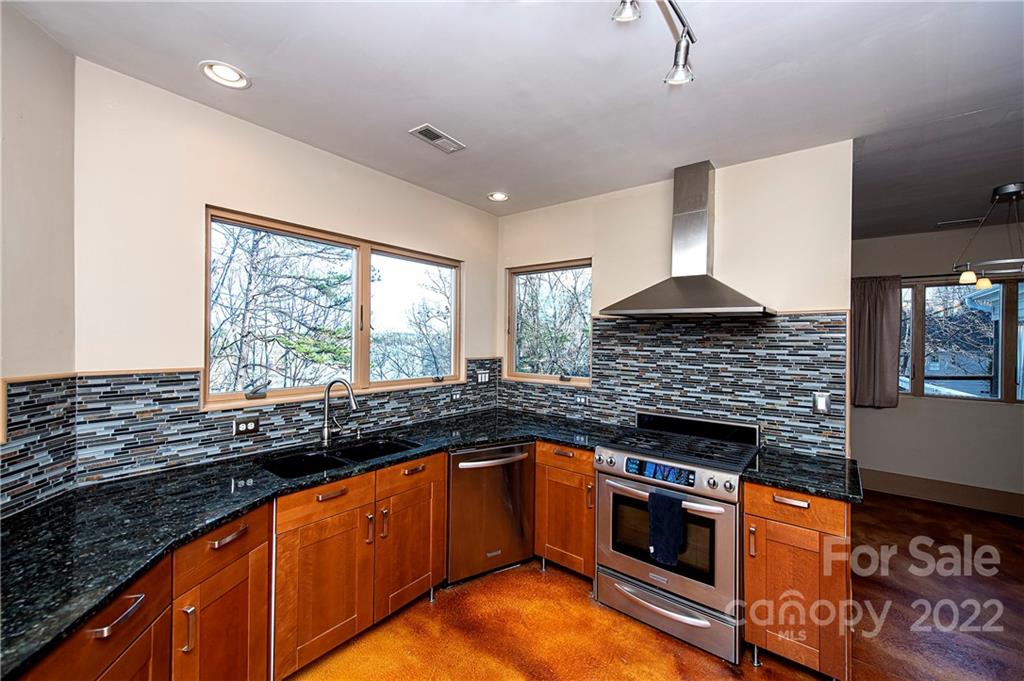 2020 Marquesas Avenue Tega Cay, SC 29708 - Photo 8 of 48 a kitchen with stainless steel appliances granite countertop a stove sink and cabinets