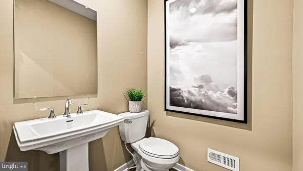 a bathroom with a sink mirror and toilet