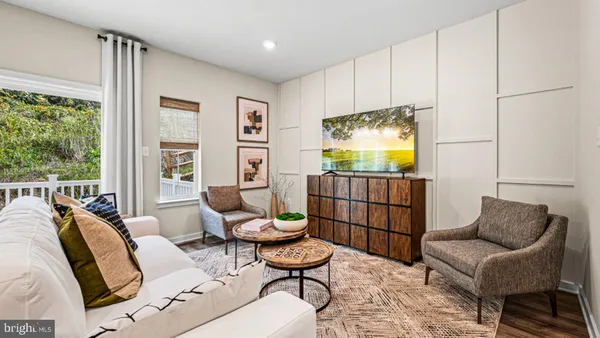 a living room with furniture a air conditioner vent and a window