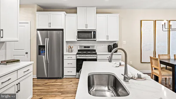 a kitchen with a refrigerator sink and stove