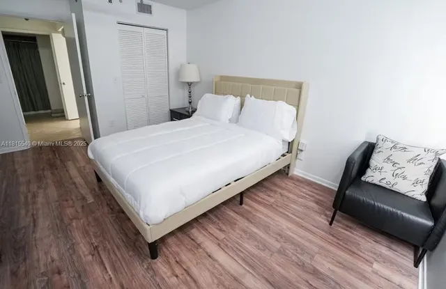 a bedroom with a bed and a couch