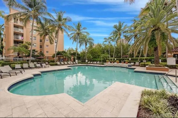 a view of a swimming pool and trees in the patio