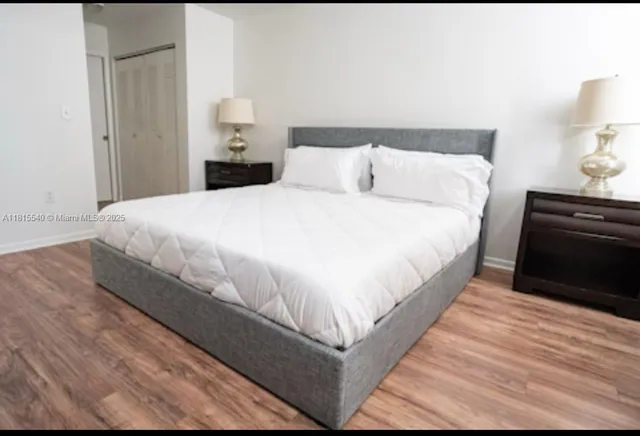 a large bed sitting in a bedroom and a lamp