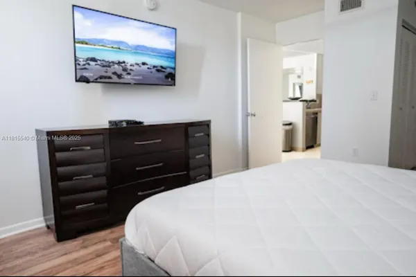a bedroom with a bed and a mirror