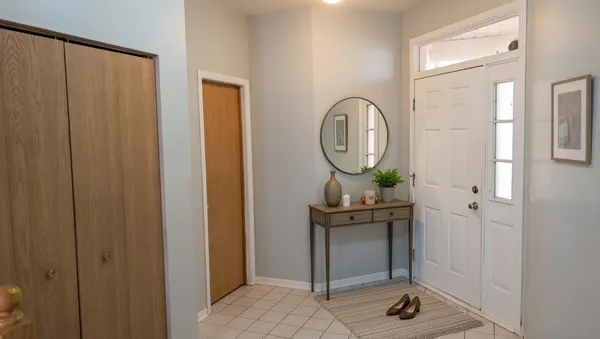 a view of a hallway with mirror on the wall