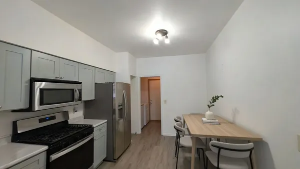 a kitchen with a table and chairs in it