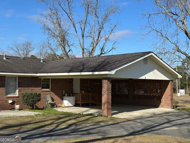 a view of a house with backyard porch and sitting area