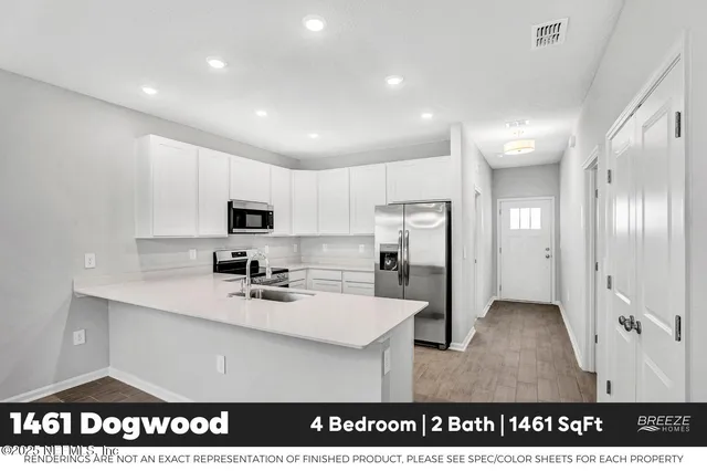 a kitchen with refrigerator and cabinets
