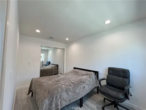 a bedroom with a bed window and couch
