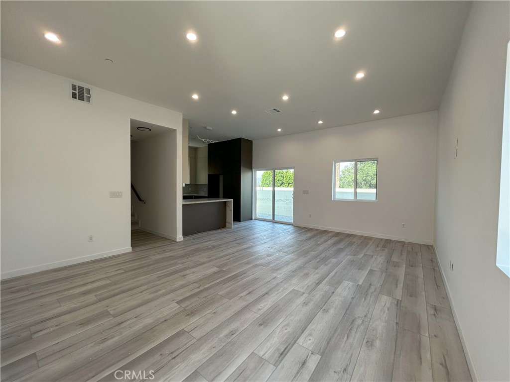 10363 Commerce Avenue Tujunga, CA 91042 - Photo 26 of 51 an empty room with wooden floor and windows