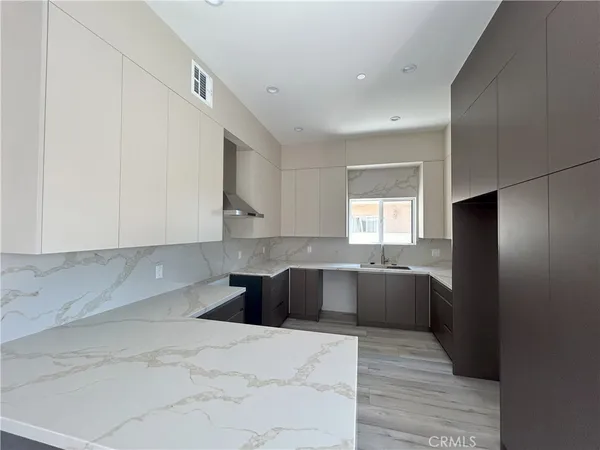 a kitchen with stainless steel appliances cabinets a sink and a stove