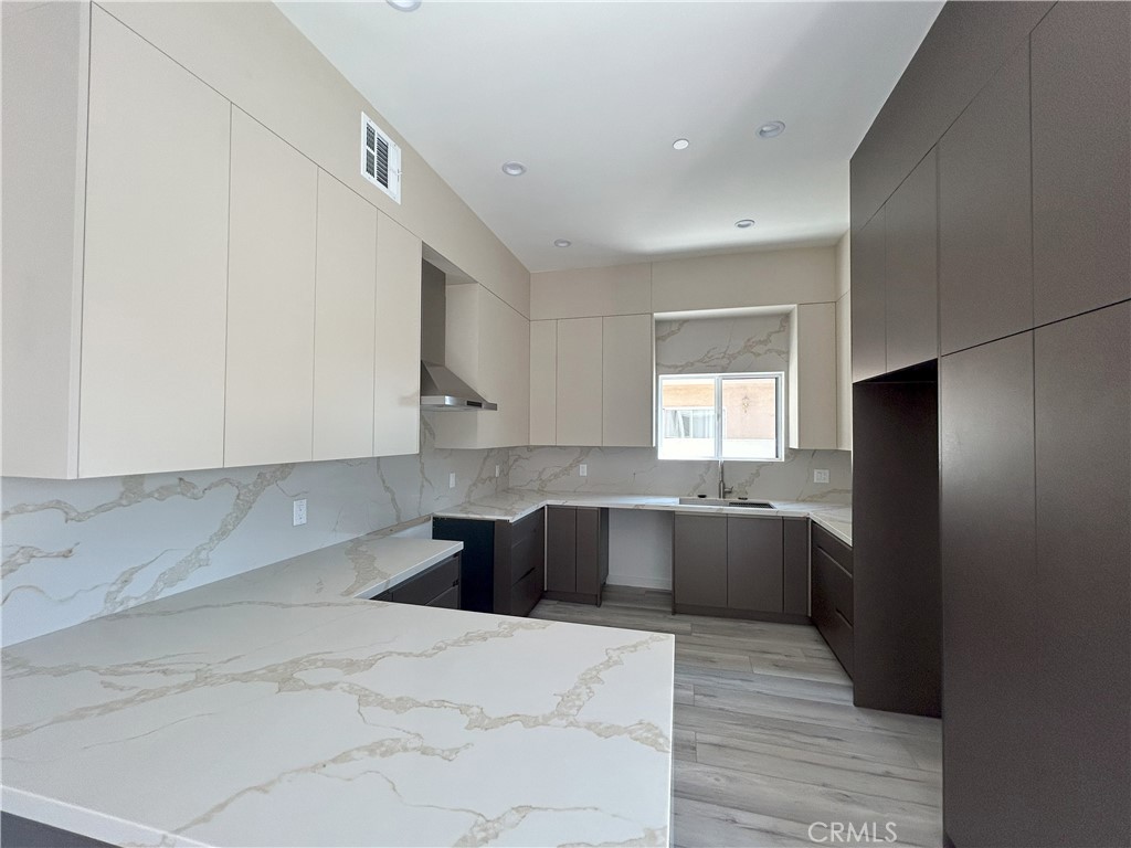 10363 Commerce Avenue Tujunga, CA 91042 - Photo 27 of 51 a kitchen with stainless steel appliances cabinets a sink and a stove