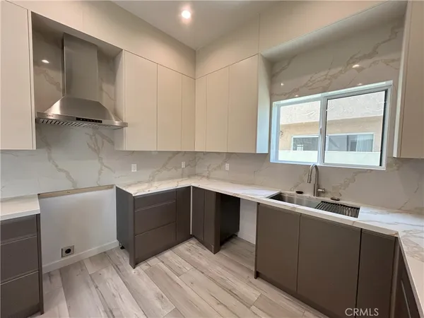 a kitchen with a sink cabinets and window