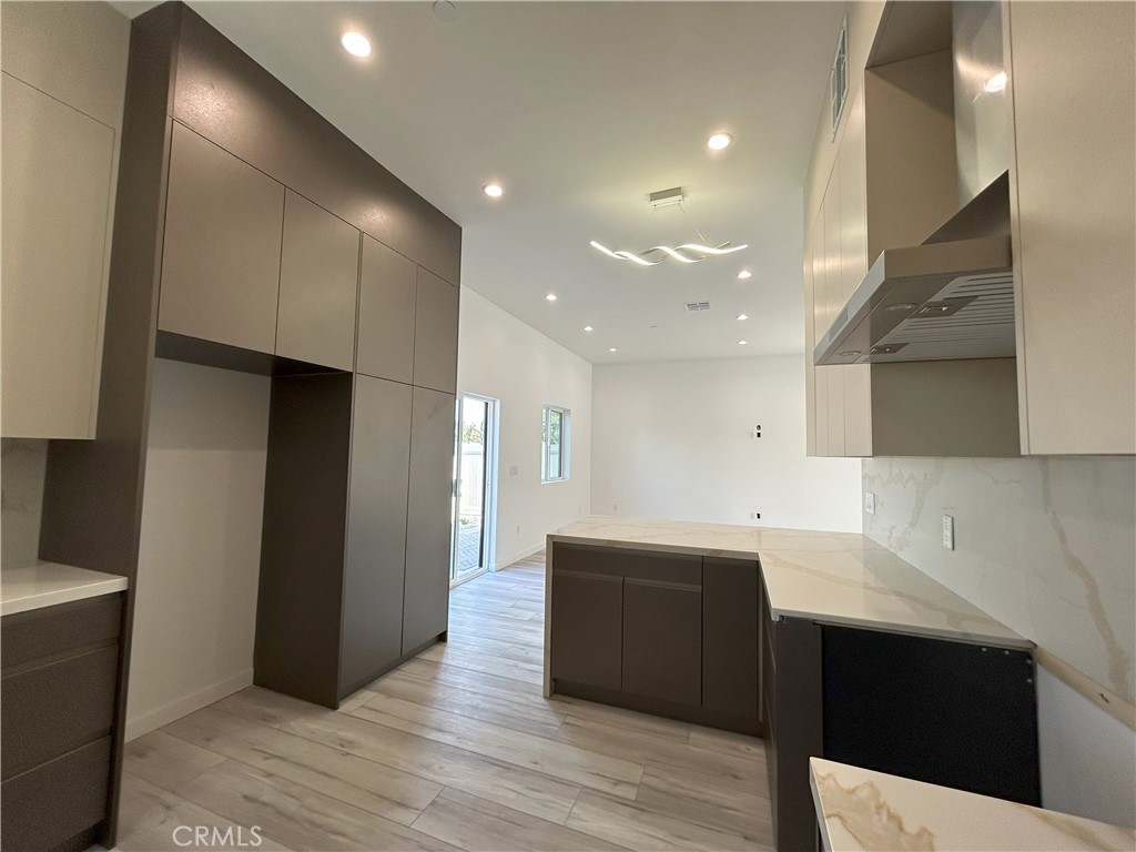 10363 Commerce Avenue Tujunga, CA 91042 - Photo 30 of 51 a large kitchen with stainless steel appliances a refrigerator and a sink