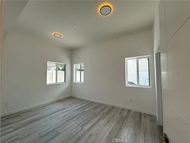 an empty room with a empty space and windows