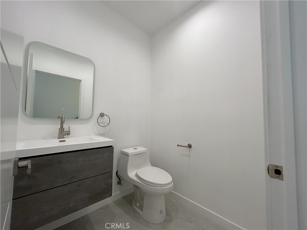 10363 Commerce Avenue Tujunga, CA 91042 - Photo 36 of 51 a bathroom with a toilet a sink and mirror