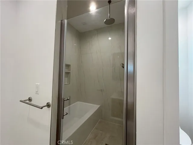a bathroom with a tub and shower