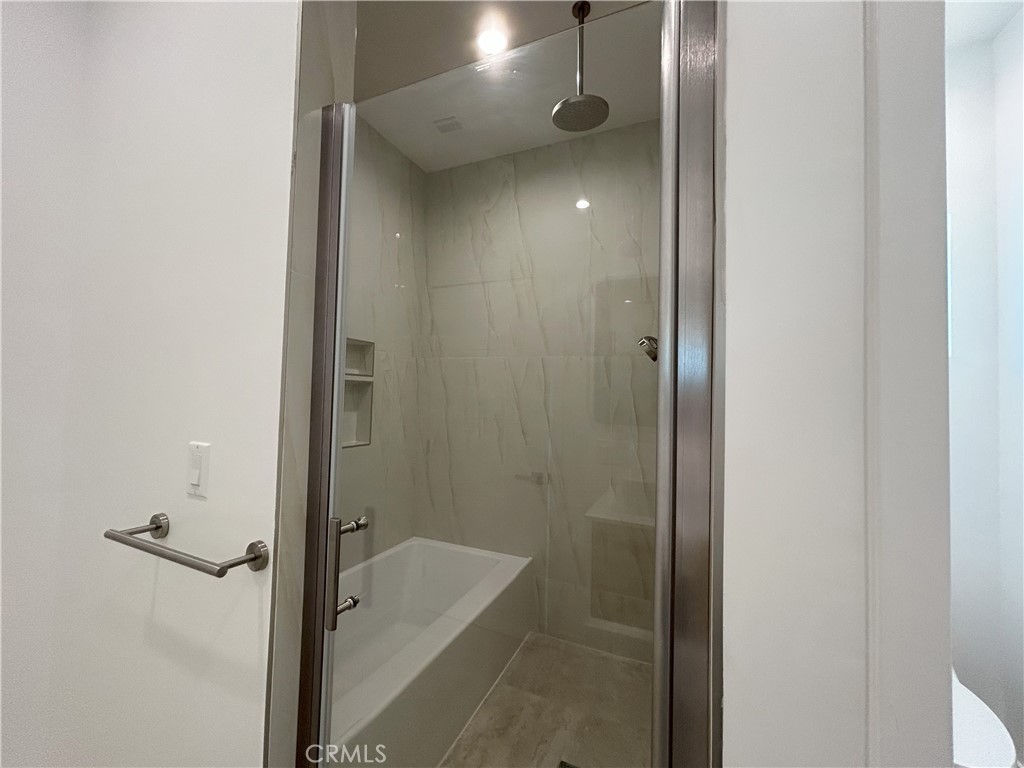 10363 Commerce Avenue Tujunga, CA 91042 - Photo 41 of 51 a bathroom with a tub and shower