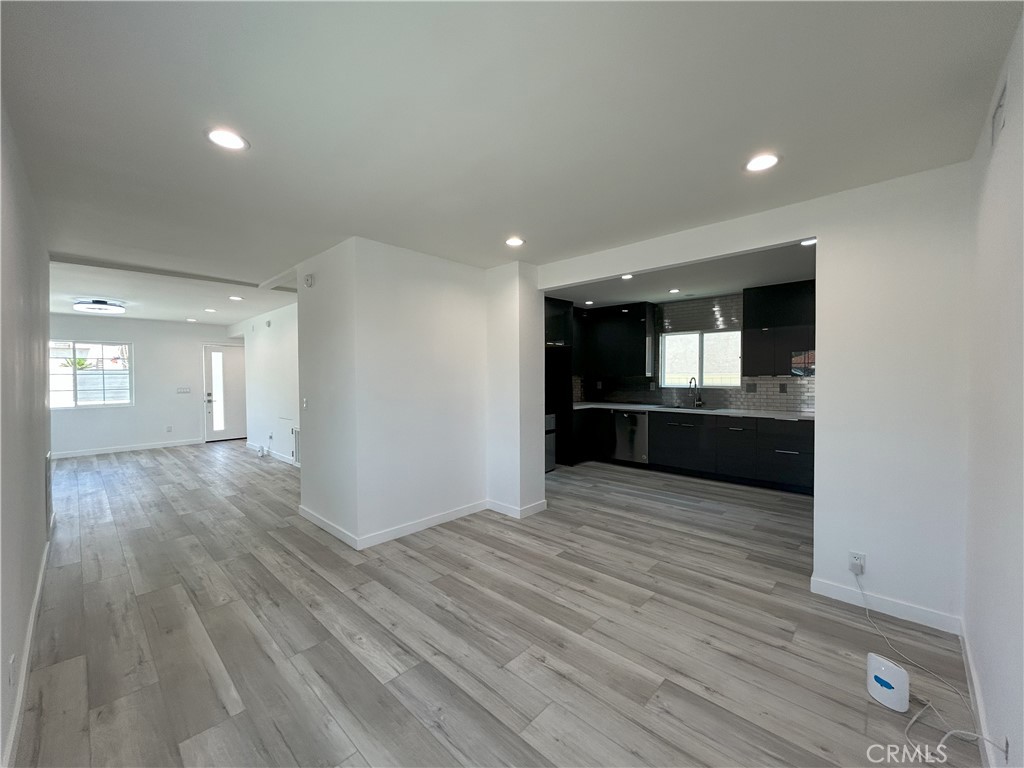 10363 Commerce Avenue Tujunga, CA 91042 - Photo 5 of 51 wooden floor in an empty room with a kitchen
