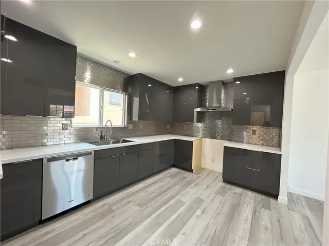 a large kitchen with stainless steel appliances kitchen island granite countertop a sink and cabinets