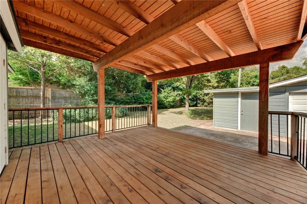 8318 Burrell Drive Austin, TX 78757 - Photo 20 of 27 Deck with a fenced backyard and an outbuilding